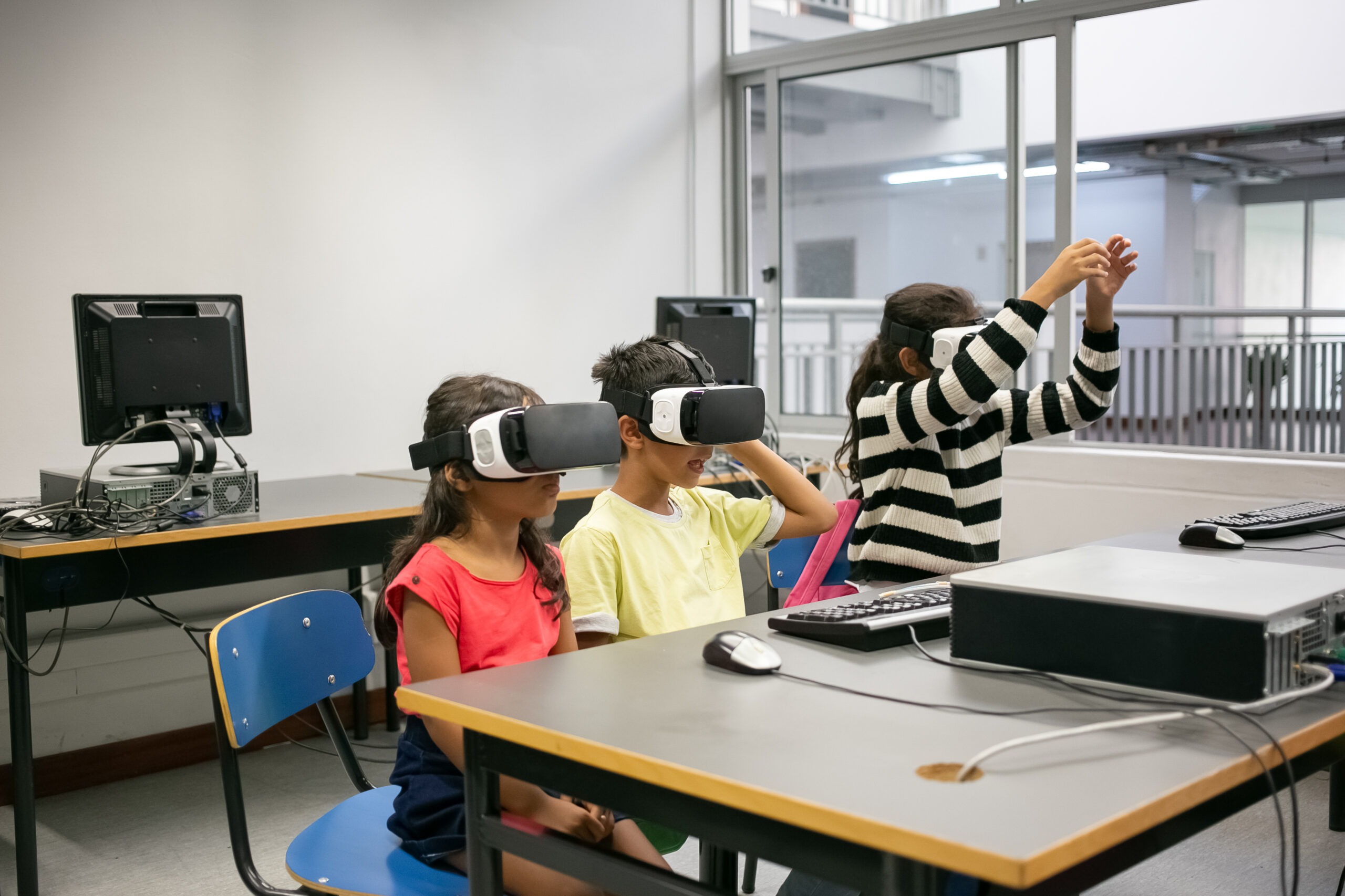 Cute multiethnic kids learning to use virtual reality glasses